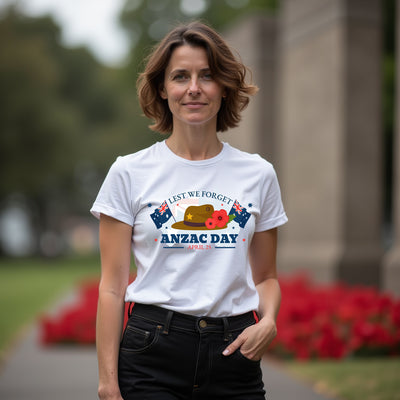 Woman wearing a white t-shirt with ANZAC Day design outdoors.