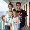 Family of three wearing matching 'Family Cruise 2026' t-shirts on a cruise ship deck.
