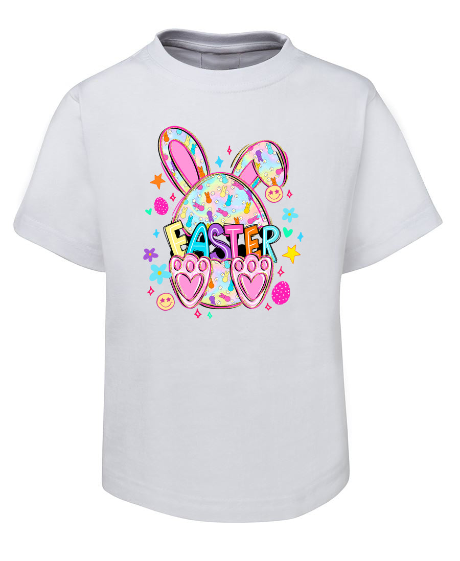 White t-shirt with Easter graphic design featuring bunny ears and colorful text on a white background
