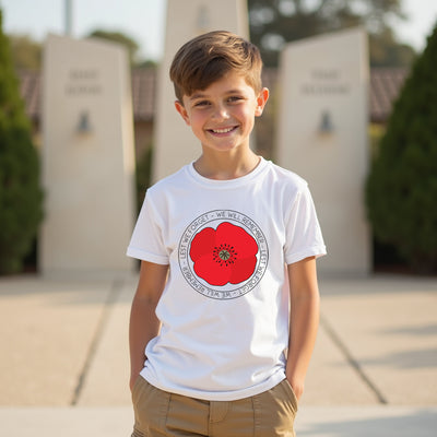Child wearing a white t-shirt with a red poppy design outdoors.