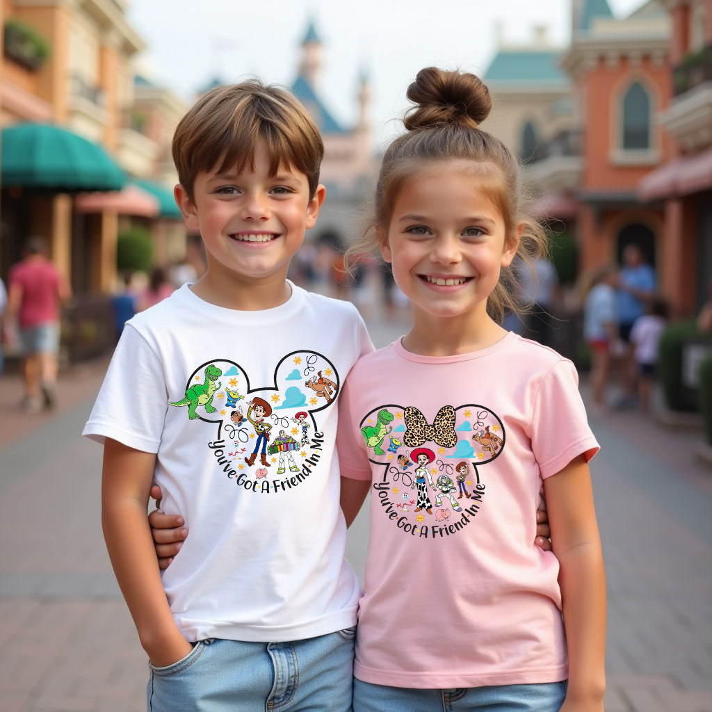 Two children wearing t-shirts with toy story cartoon character designs in a theme park setting.