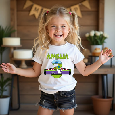 Young girl wearing a white t-shirt with a colorful buzz lightyear design and name, standing in a home setting.