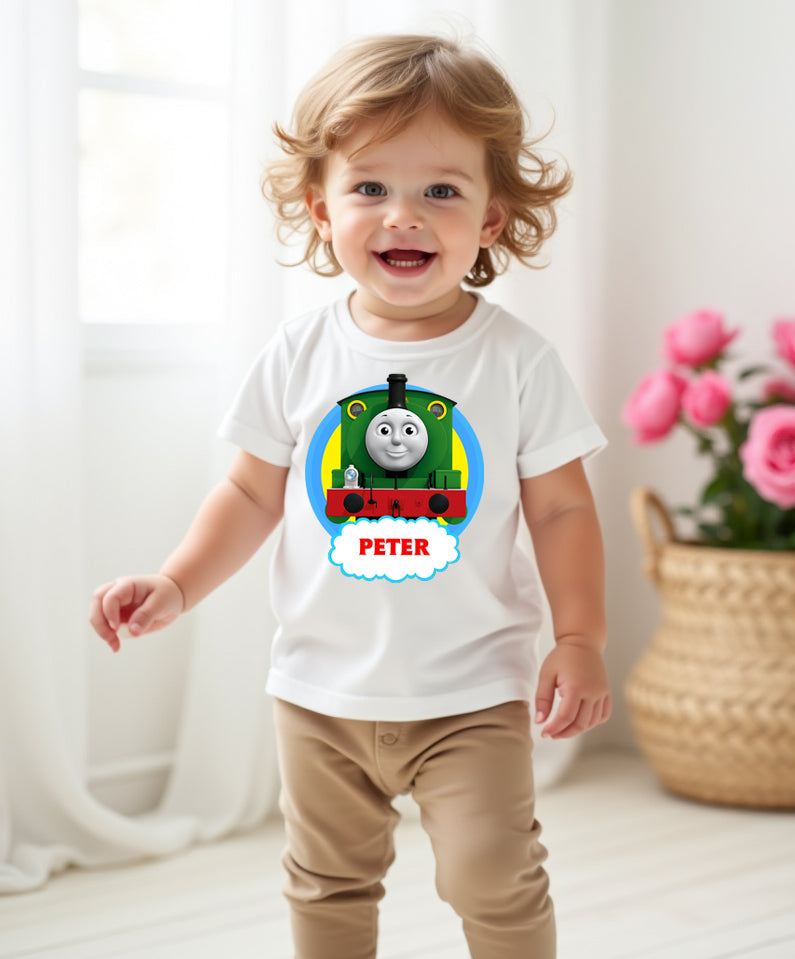 Child wearing a white t-shirt with a colorful train design and the name 'Peter' on a light background.