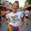Woman wearing a Mardi Gras-themed t-shirt with colorful graphics in a festive setting.