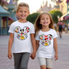 Person wearing Happiest Place on Earth t-shirt styled for a themed birthday party or casual day out.