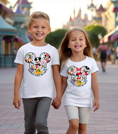 Person wearing Happiest Place on Earth t-shirt styled for a themed birthday party or casual day out.