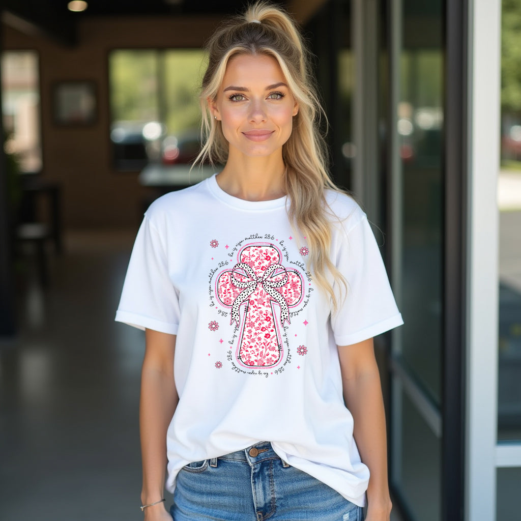 Woman wearing a white t-shirt with a red floral cross design in an indoor setting