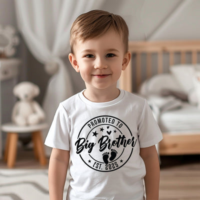 Young boy wearing “Promoted to Big Brother” shirt, perfect for celebrating a new baby on the way and family photos.