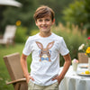 Child wearing a white t-shirt with a cartoon bunny design for easter