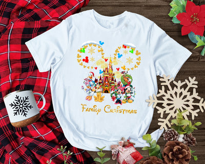 Festive Disney-inspired Christmas shirt featuring snowy castle scene and gold sparkle Mickey ears