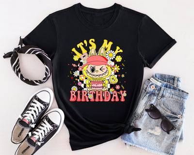 Bright yellow Labubu birthday t-shirt with cheerful monster character and party design details.