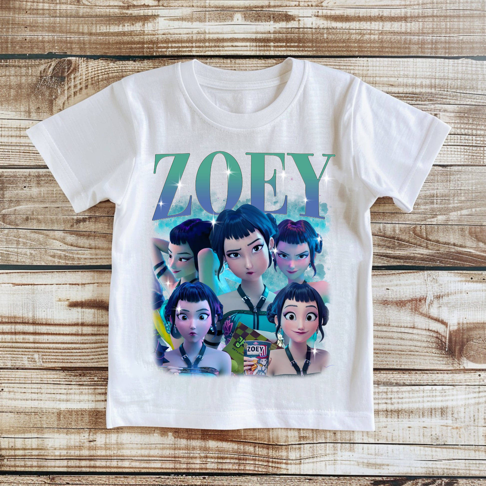 White t-shirt with animated character design and 'ZOEY' text on a wooden surface