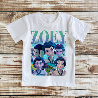 White t-shirt with animated character design and 'ZOEY' text on a wooden surface